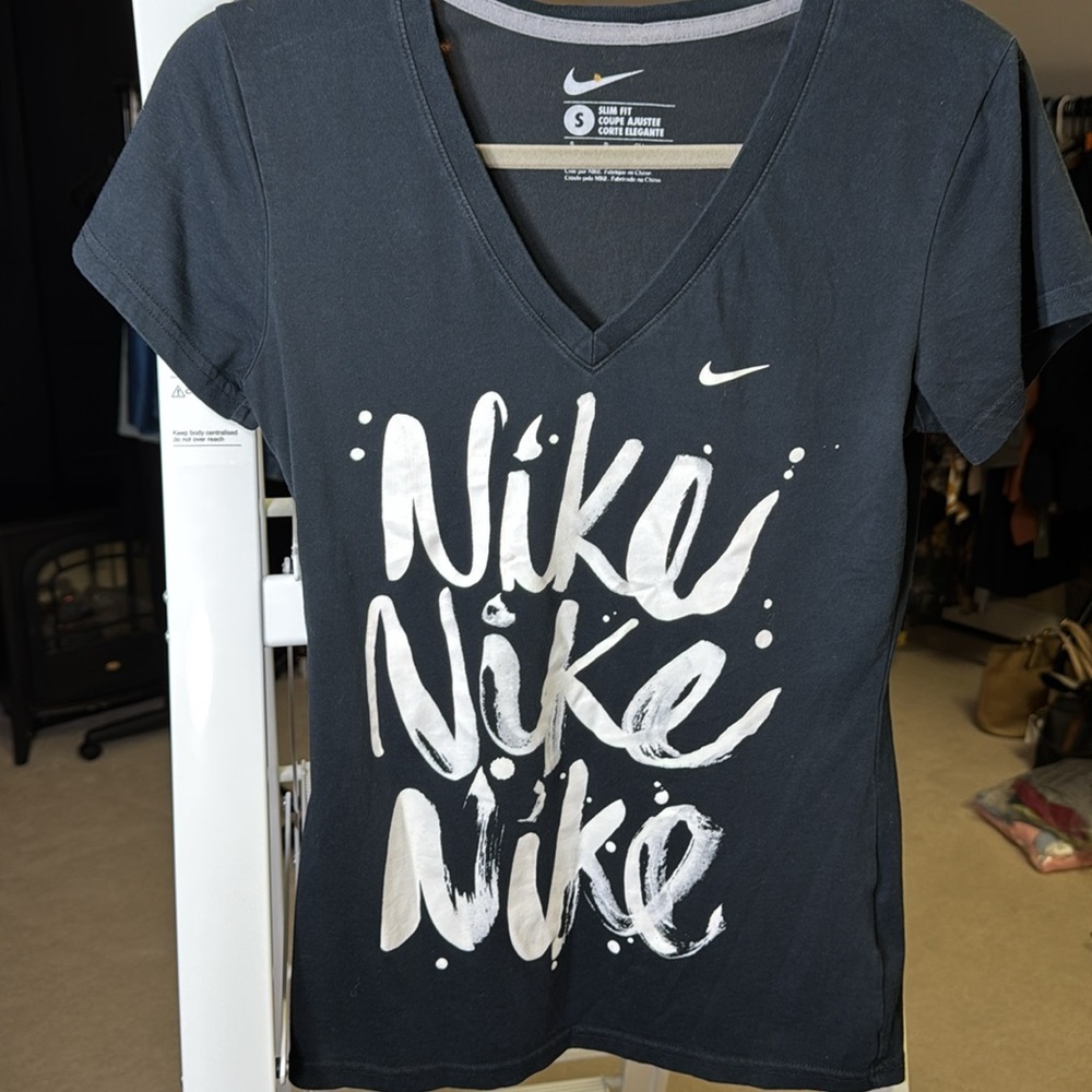Nike slim fit women’s small t-shirt with multiple Nike graphic black with white‎